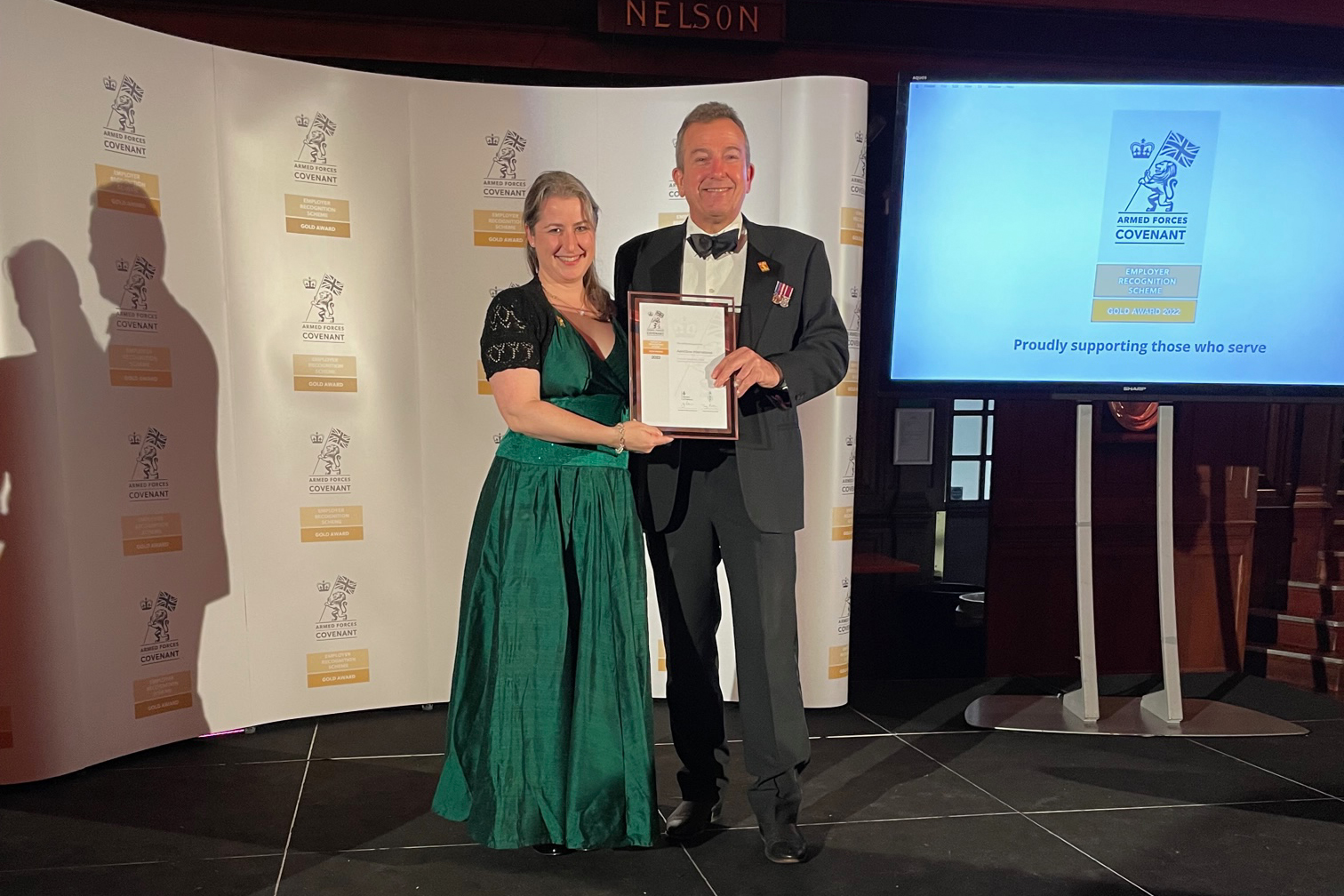 Keith White and Laura Shapland holding ERS Gold Award on stage